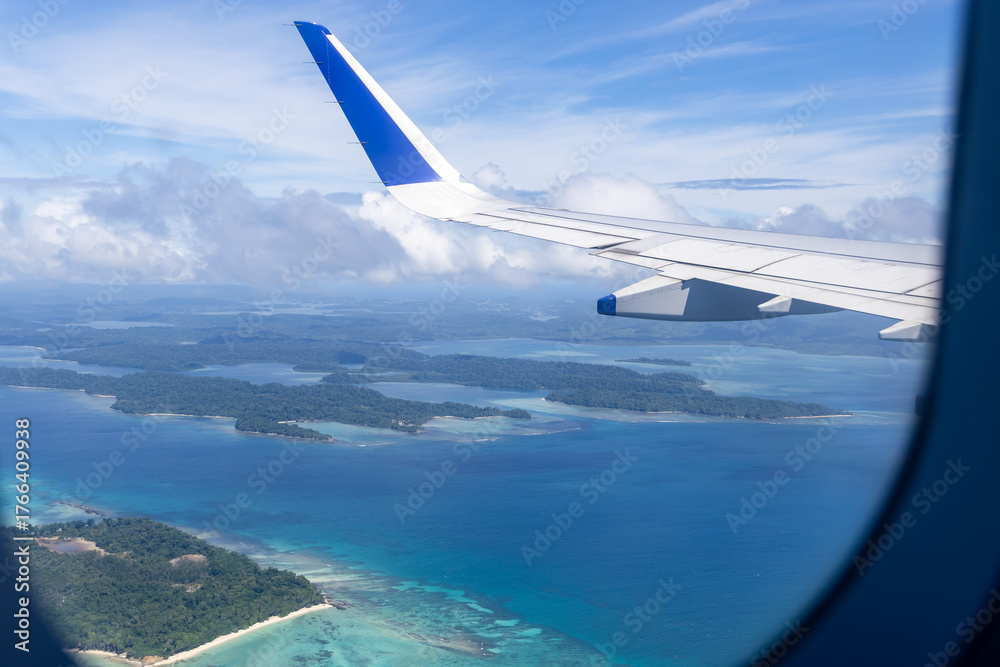 Obraz premium airplane wing view above clouds during daylight flight