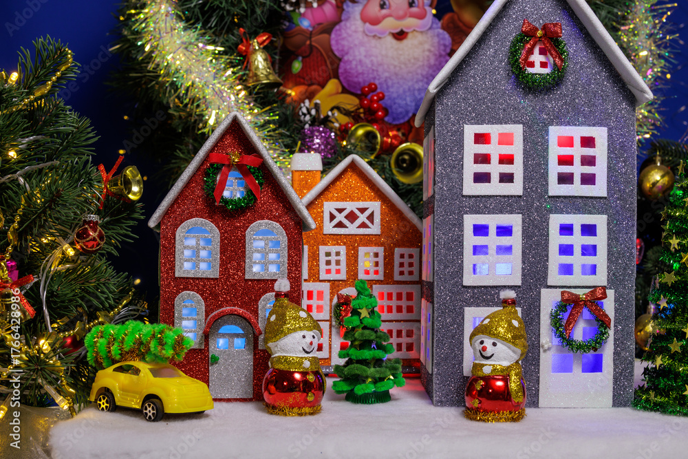 Naklejka premium In the Christmas village, colorful large houses are surrounded by Christmas trees and snowmen