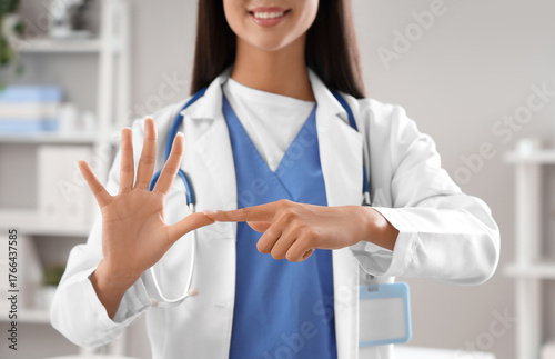 Female doctor using sign la...