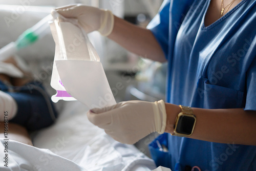 Fotografie Nurse hands opening sterile dressing package for patient