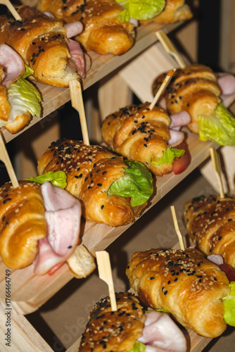 Vertical Display of Gourmet Mini Croissant Sandwiches