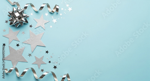 Minimalist blue pastel flatlay New Year background with silver stars and ribbons