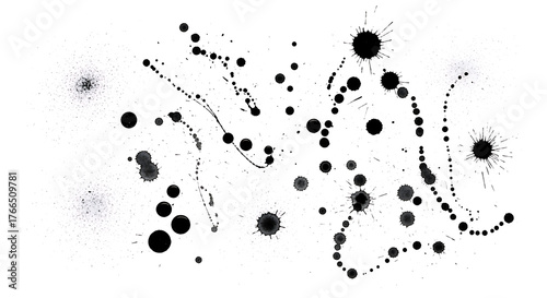 Abstract arrangement of black ink splatters and dots on a white background creating a dynamic composition