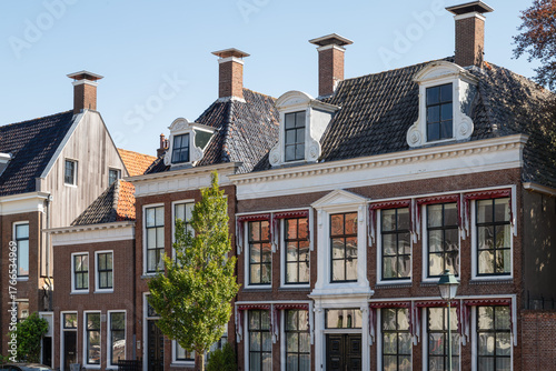 Facades of historic canal houses in the center of Harlingen in the Netherlands.