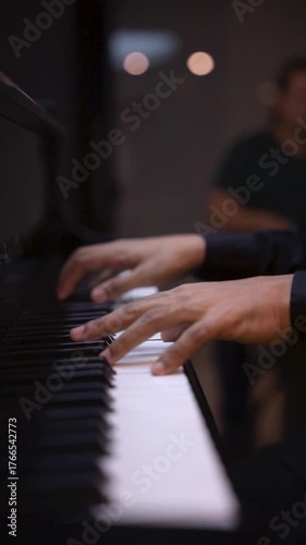 Close-Up Hands of Young Man Playing Piano Under Low Light Music Performance and Practice Concept