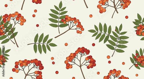 Autumnal seamless pattern featuring vibrant orange and red rowan berries and their distinctive green leaves on a light background.