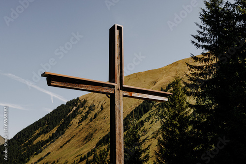 Wooden cross on a mountain slope near Fallerschein, Tyrol, Austria – symbol of faith in the Alps