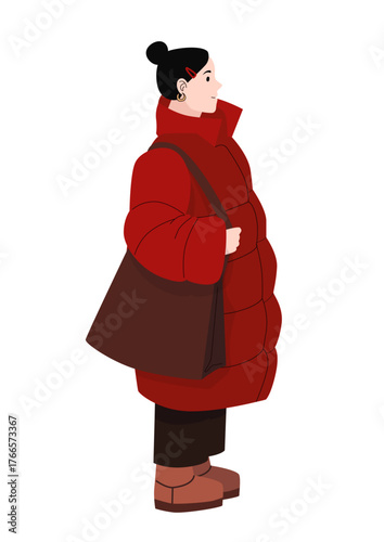 Young woman in red winter coat with brown shoulder bag and boots standing in profile isolated on white background