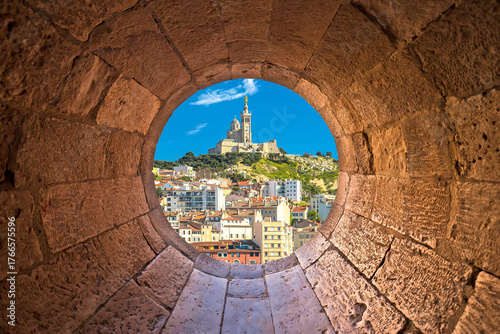 City of Marseille Notre Dame de la Garde church on the hill view through stone carved window