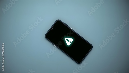 Flat lay of modern smartphone with glowing alert symbol, gray surface