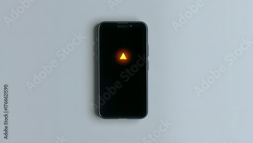 Flat lay of modern smartphone with glowing alert symbol, gray surface