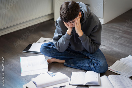 A young student looking tired and bored during school homework, reflecting the challenges of modern education and study fatigue among youth.