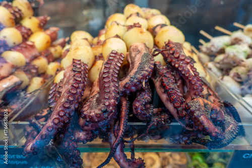 Spanish starter dish in fish restaurant in Getaria, grilled octopus with roasted potatoes and paprika, Basque Country, Spain