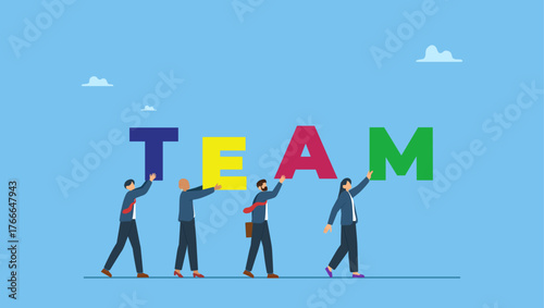 Business team people walking together holding the word TEAM. Team working together to win business success, teamwork, cooperation or collaboration, coworker partnership or office colleagues.