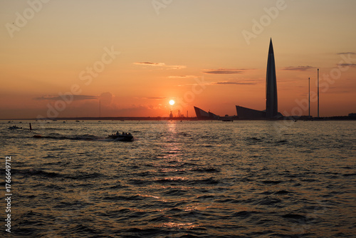A breathtakingly stunning sunset over the water alongside a magnificent city skyline
