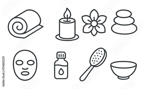 Spa essentials: candle, rolled towel, stones, flower, face mask, oil, brush, bowl