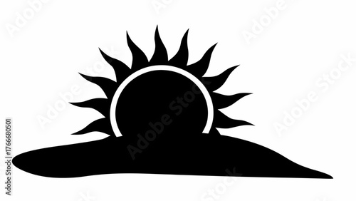 Silhouette of a sun rising or setting over a dark landmass with radiating light rays in black and white