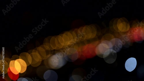 Beautiful bokeh lights shimmer softly in the darkness.