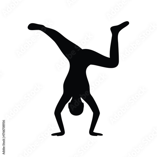 Silhouette of a person performing a handstand with legs raised in air
