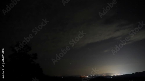 Time-lapse of a starry night sky, and an airplane flying through a starry night sky