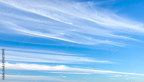 Fototapeta Naklejka Na Ścianę i Meble -  Wispy cirrus clouds streaking across a bright blue sky