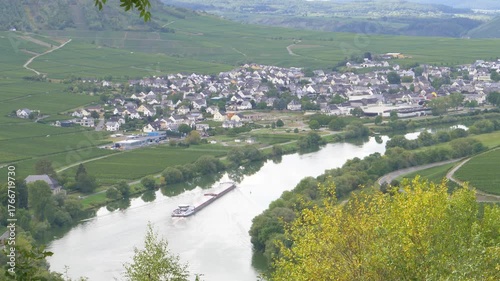 Cargo ship navigating moselle river near small german town Trittenheim