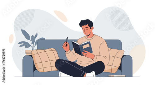 A man reading and writing in a journal while relaxing on a comfortable sofa at home