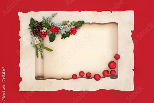 Christmas paper scroll on parchment paper on red sphere ball bauble decorations, traditional winter holly and flora. Party invitation or letter to Santa design.