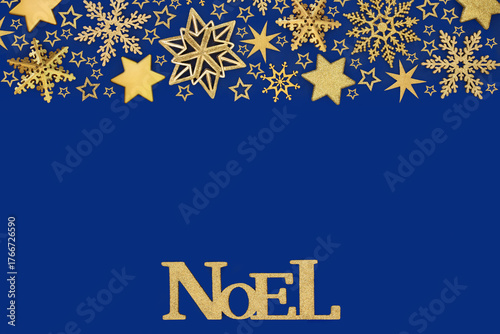 Xmas noel sign with gold star, snowflake bauble decorations on blue  background. Festive luxury design concept for holiday Christmas season. Greeting card.