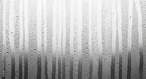 Obraz na płótnie Abstract background of water droplets on glass with vertical stripes creating a textured and visually interesting pattern for design elements