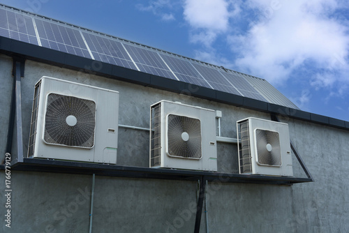 Air compressor or air condenser unit located on support outside building to heat released transferred to surrounding environment, Compressor is part of cooling function and air conditioning HVAC syste