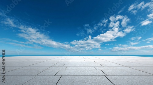 Expansive concrete floor meets infinite blue sky with soft white clouds, creating a minimalist landscape of geometric precision and ethereal openness