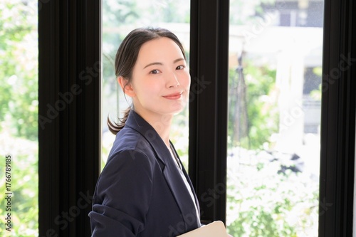 Free Download 緑が見えるオフィスでパソコンを持つ日本人女性 - GFXLoad