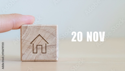 A hand holds an iconic wooden cube with a house symbol for a special international day on November 20th