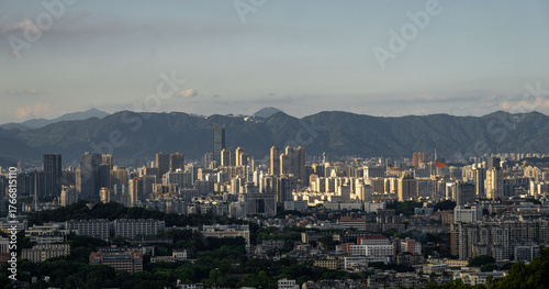 Fototapeta Naklejka Na Ścianę i Meble -  A Panoramic View of the City Skyline with Distant Mountains in the Background