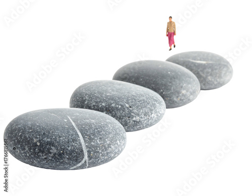 A row of four gray smooth stones, leading to a tiny person, against a black background