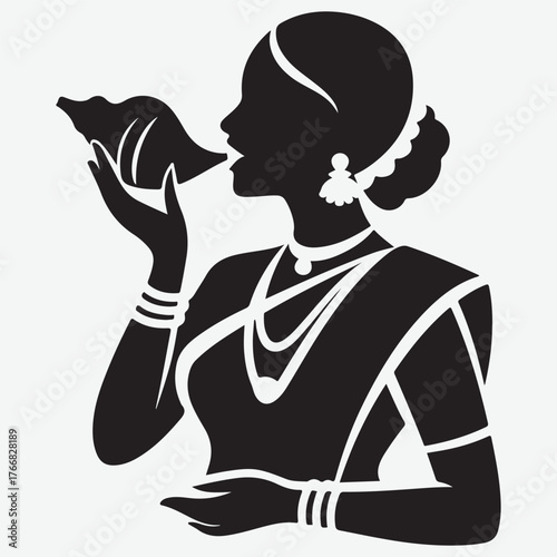 Silhouette of a Woman in Traditional Indian Attire Blowing a Conch Shell