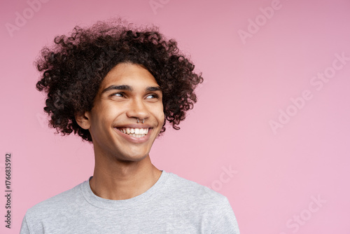 Happy young man smiling with curly hair