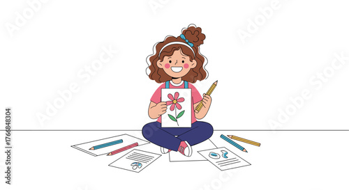 A cheerful girl sits on the floor, proudly holding up her vibrant flower drawing, surrounded by pencils and other artwork.