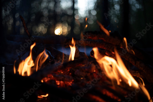 A bonfire at sunset. Flame against the sunset. Yellow flames of a bonfire.
