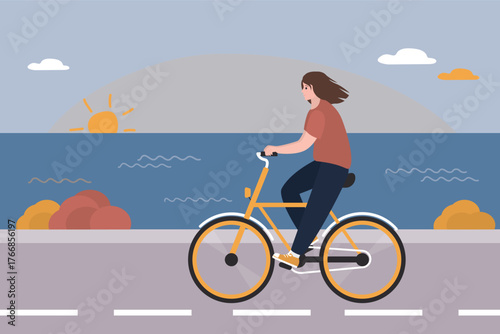 Happy woman riding bicycle on seacoast. Beauty girl riding bike. Bike path on embankment, beautiful sunset. Ocean view on background. Cycling, free time, activity at weekend.