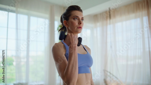 Free Download Fit lady lifting dumbbells at home training arms straight closeup. Woman fitness - GFXLoad