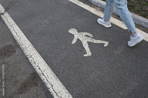  Person walking on designated walkway.