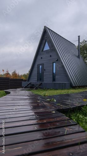 Wallpaper Mural Modern A-frame cabin with a wooden walkway on a cloudy day Torontodigital.ca