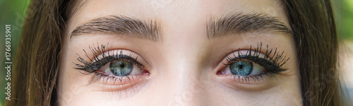 Beautiful girl's made-up eyes looking to camera