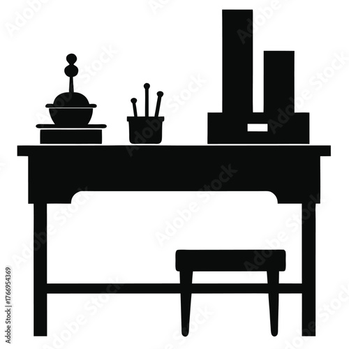 Solid black silhouette reveals a wooden desk with a stool and tools