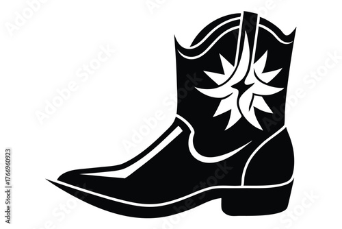 Black cowboy boot shows intricate western details on a plain white backdrop