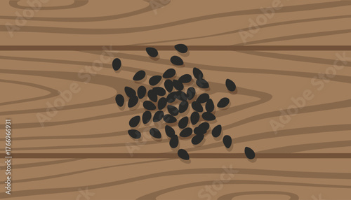 A close-up, top-down view of a pile of small, black sesame seeds scattered across a textured wooden surface, highlighting their natural shape and dark color against the warm, grainy wood grain