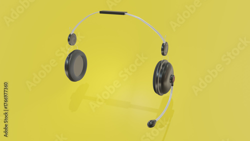 realistic black headphones on a yellow background