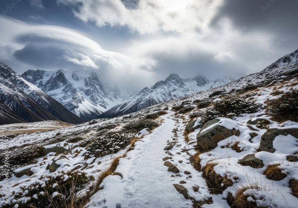 Fototapeta premium Majestic snowy mountain landscape trail under dramatic cloudy sky serene outdoor adventure